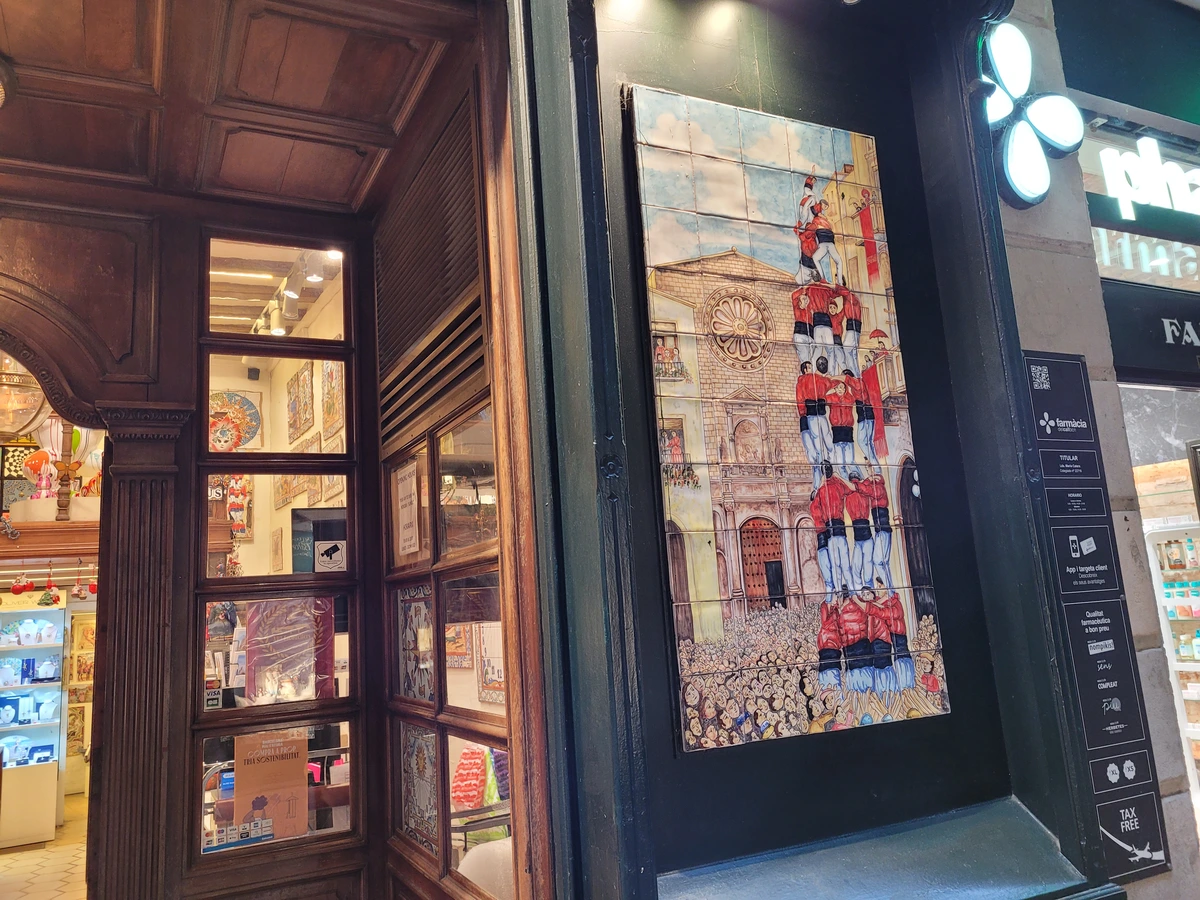 Mosaic with Catalan castellers on a shop with traditional souvenirs